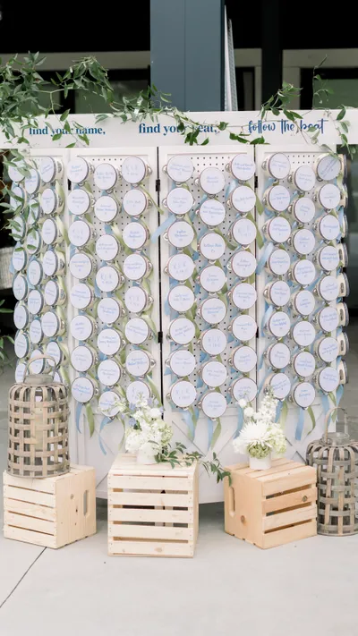 Calligraphy tambourine escort card display for a wedding